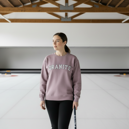 woman wearing rose crewneck sweatshirt with GRANITE printed across the chest