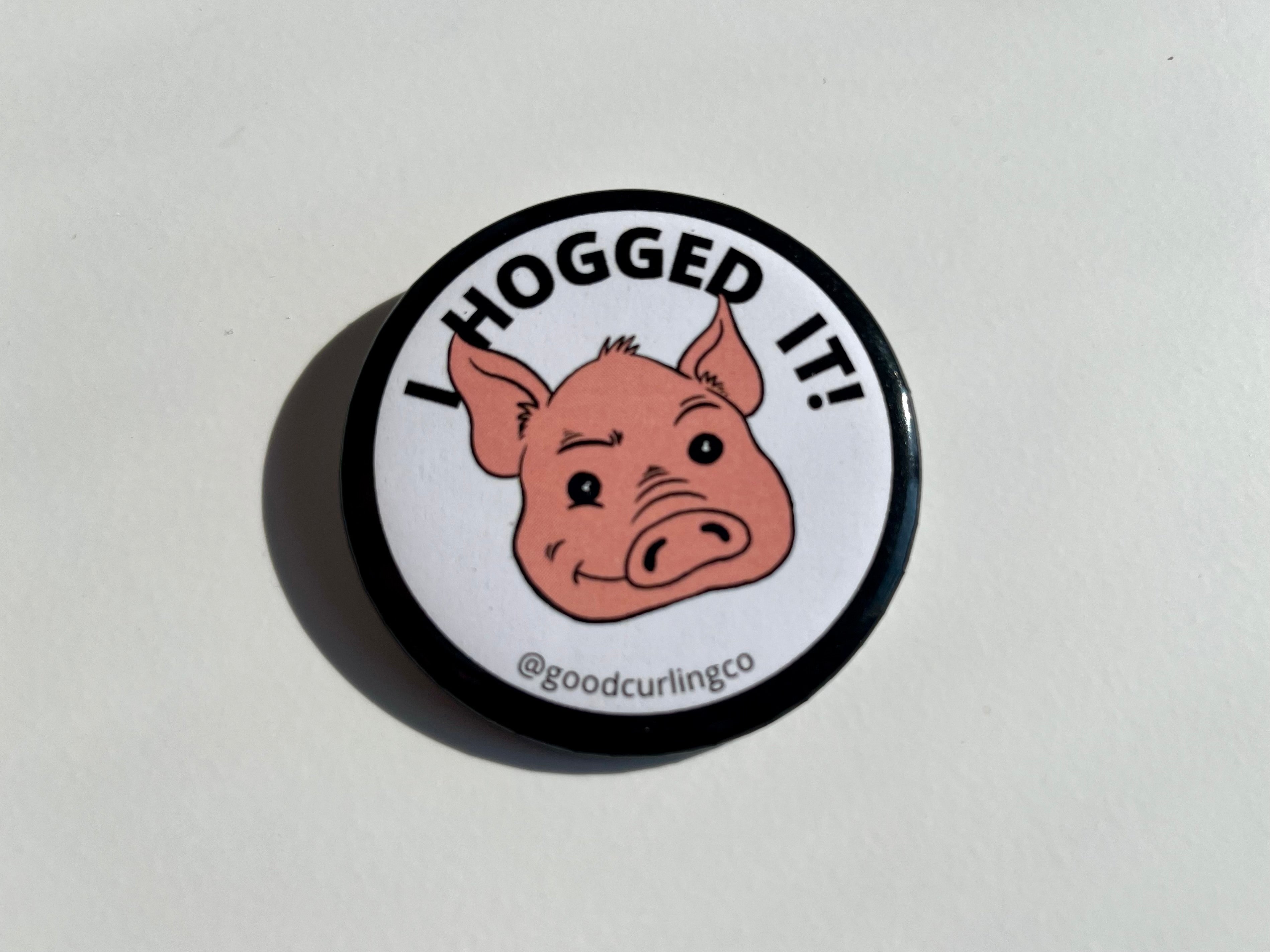 Button badge with a pig illustration and text 'I HOGGED IT!' on a white background